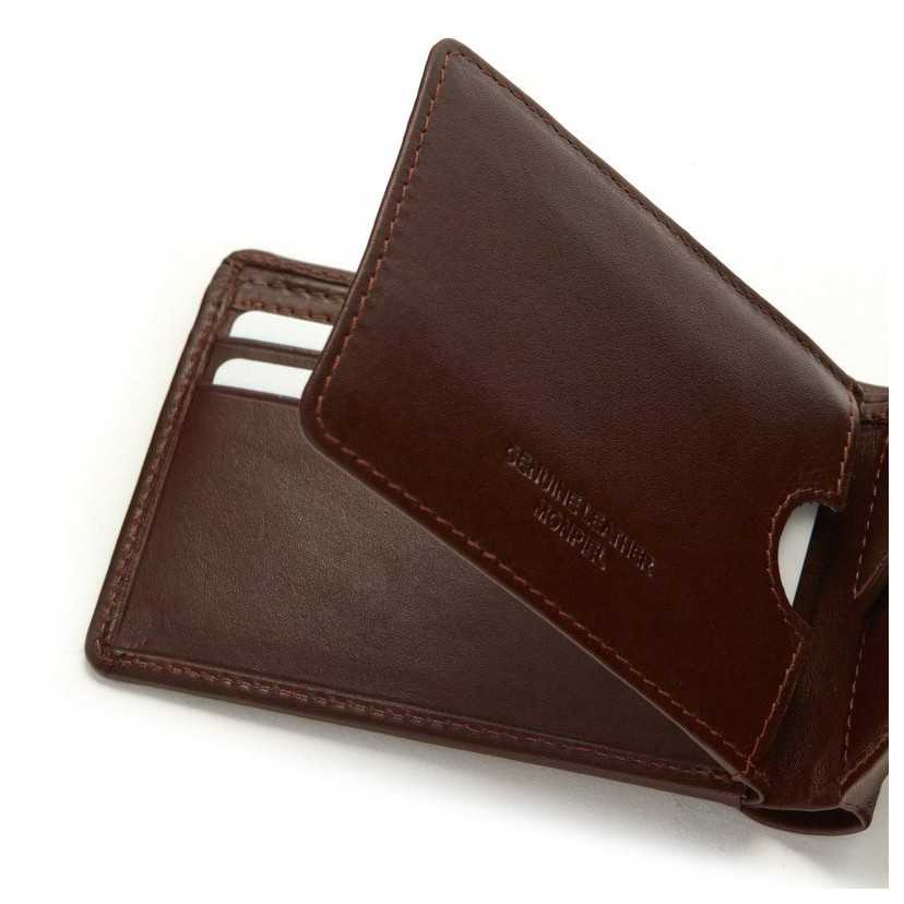 Small brown leather American-style wallet, close-up detail of cards, on a white background - MONPIEL