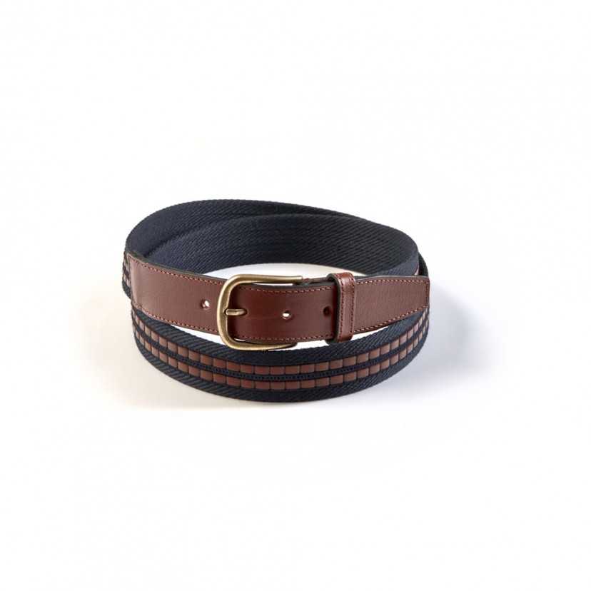 Men’s navy canvas and leather belt, coiled, on a white background - MONPIEL