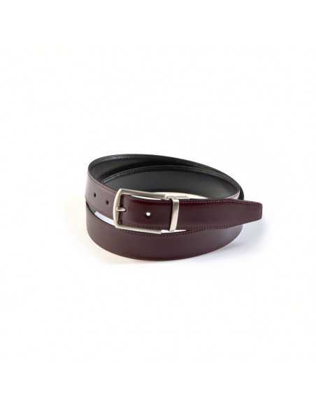 Black and burgundy leather belt with metal buckle, coiled on white background - MONPIEL