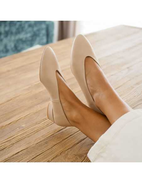 Beige heeled ballerina shoes, detail of crossed feet on a table, perspective view - MONPIEL