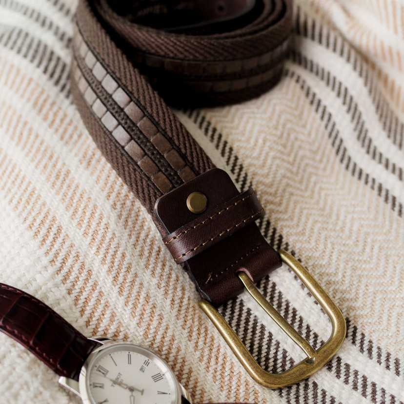 Men’s brown canvas and leather belt, close-up focusing on the buckle, on a blanket - MONPIEL