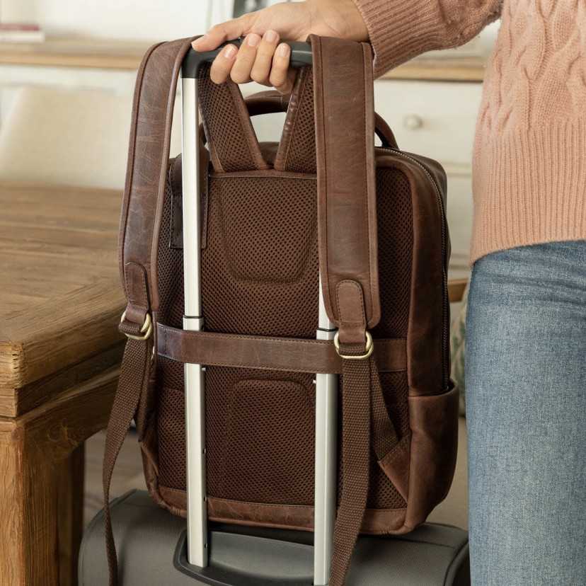 Brown leather backpack, rear view, resting on a suitcase - MONPIEL