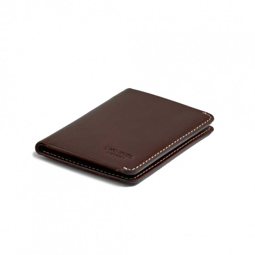 Small men's leather wallet in brown, perspective view on a white background - MONPIEL