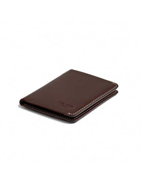 Small brown leather men’s wallet with bill compartment, perspective view on white background - MONPIEL