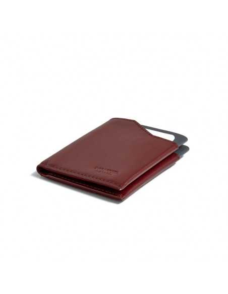 Burgundy leather pocket wallet, shown in perspective on a white background - MONPIEL Burgundy leather pocket wallet, shown in perspective on a white background - MONPIEL
