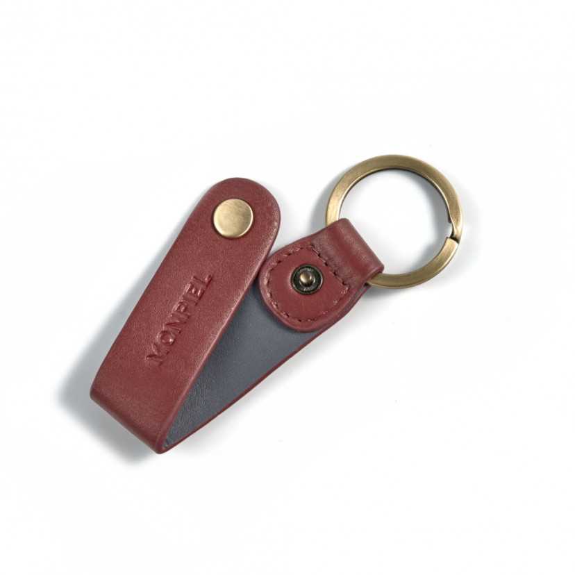 Burgundy and tan leather pocket keychain, open with button detail on a white background - MONPIEL