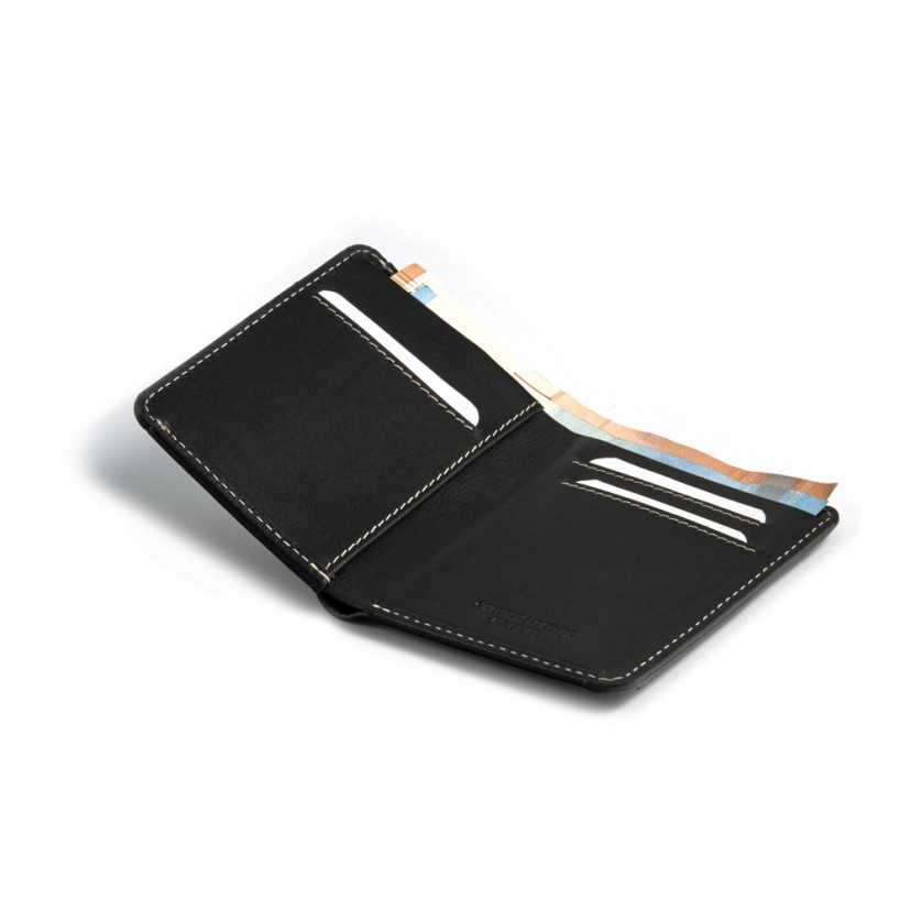 Small black leather men's wallet with billfold, open with card slot details on a white background - MONPIEL
