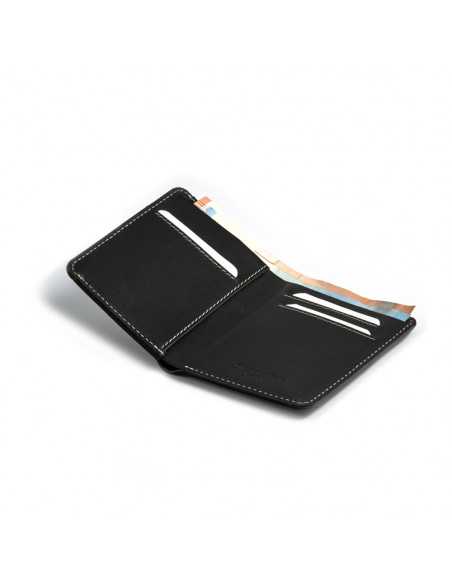Small black leather men's wallet with bill compartment, open, showing card slots, on white background - MONPIEL