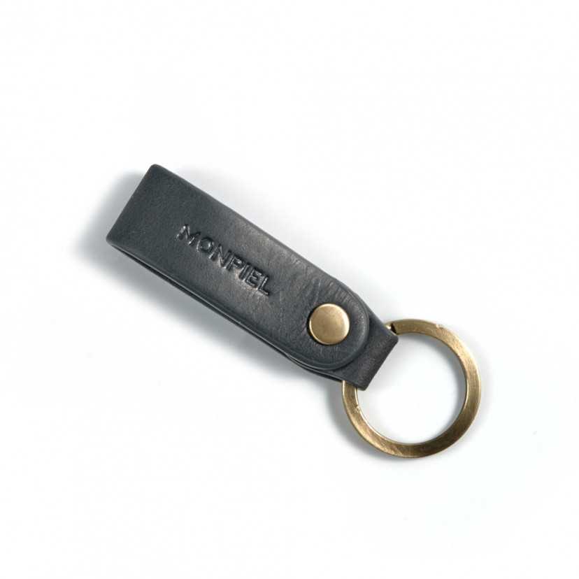 Blue leather keychain, closed and slightly tilted with logo detail on a white background - MONPIEL