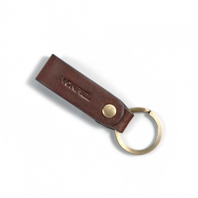 Brown unisex leather keychain, closed and slightly tilted on a white background - MONPIEL