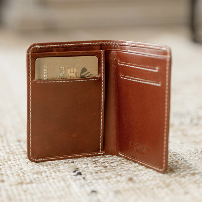 Small Havana leather men's wallet with billfold, open with card slot details on a carpet - MONPIEL