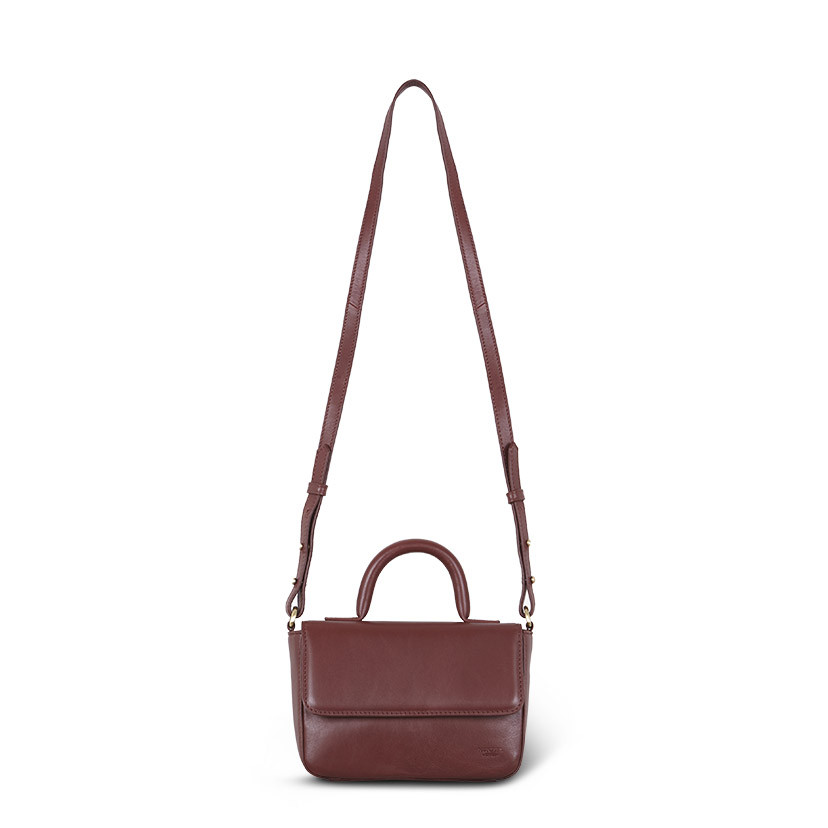 Small Armado leather bag in brown, shown from the front with long handle on a white background - MONPIEL