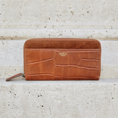 Women's leather zipper wallet in tan, shown in perspective resting on a vase - MONPIEL 2