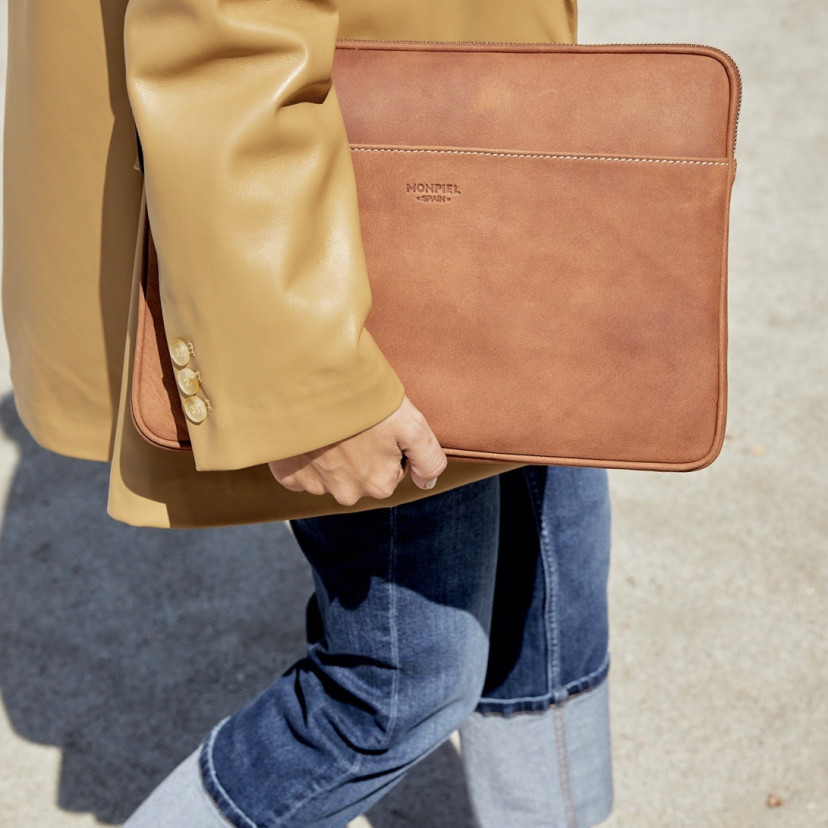 13" and 14"-inch leather laptop sleeve in tan, held by hand with an outdoor background - MONPIEL