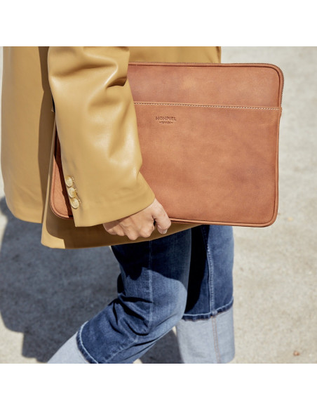Leather laptop sleeve for 13" and 14" inches in leather color held by hand with outer background - MONPIEL