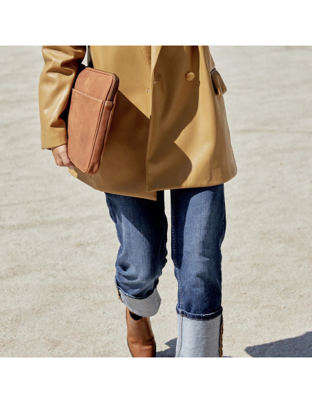 13" and 14"-inch leather laptop sleeve in tan, shown from the side held by hand with an outdoor background - MONPIEL
