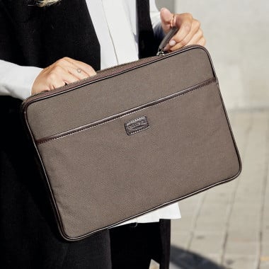 13" and 14"-inch green leather sport laptop sleeve, shown from the front on a wooden table - MONPIEL 2