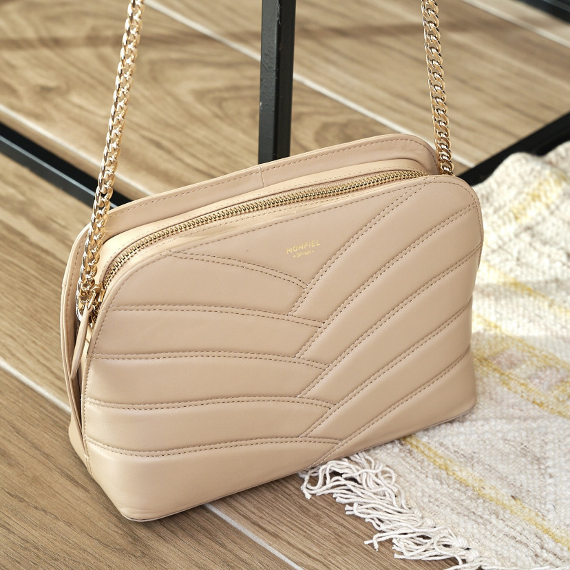 Beige leather quilted bag with gold chain, worn and shown in perspective - MONPIEL