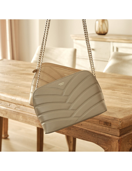 Quilted leather bag with gold chain in taupe with a beige bag in the background - MONPIEL
