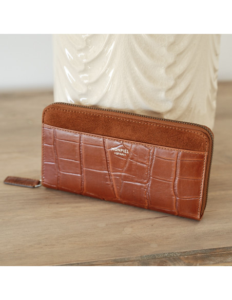 Women's leather zipper wallet in tan, shown in perspective resting on a vase - MONPIEL