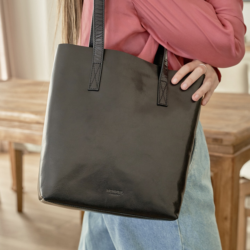 Bolsa shopper de couro na cor preta pendurada no ombro com vista frontal - MONPIEL