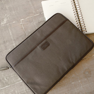 13" and 14"-inch green leather sport laptop sleeve, shown from the front on a wooden table - MONPIEL 2