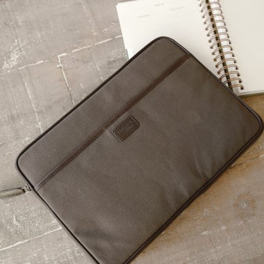 13" and 14"-inch green leather sport laptop sleeve, shown from the front on a wooden table - MONPIEL 2