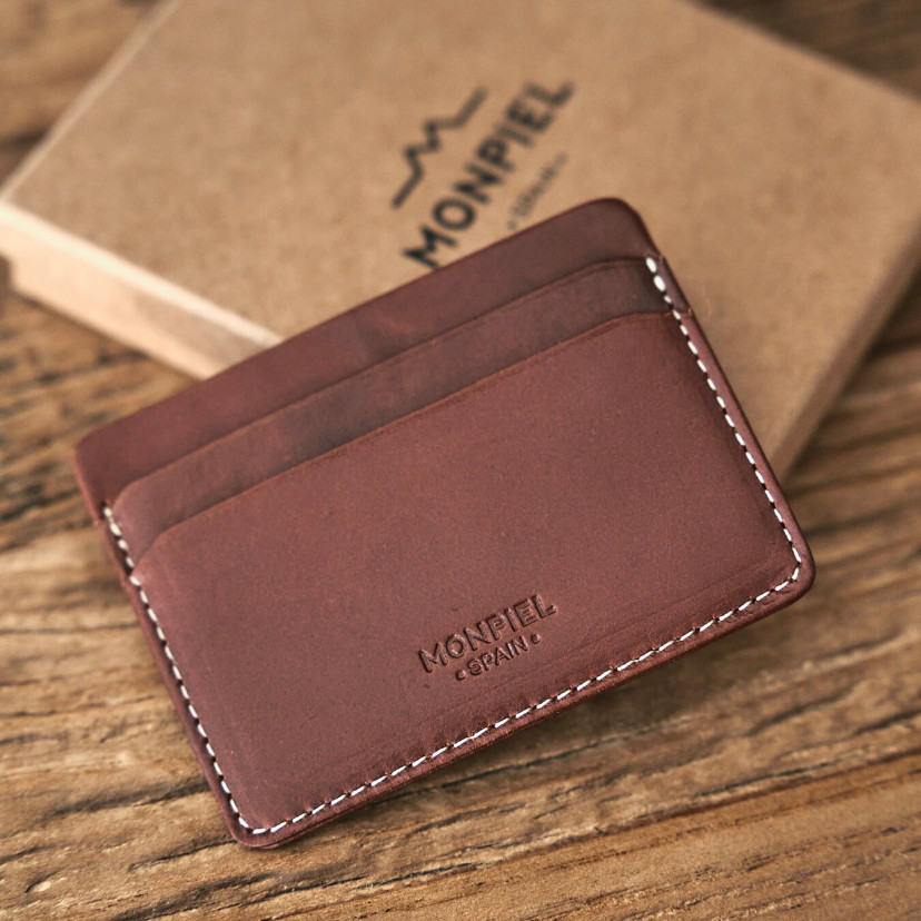 Mini Havana leather cardholder, shown from the front and slightly tilted, resting on its box - MONPIEL