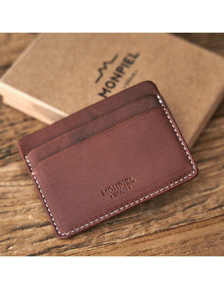 Mini leather cardholder in Havana color with front view, slightly tilted, resting on its box - MONPIEL
