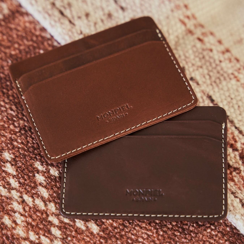 Mini brown and Havana leather cardholders, resting on a carpet with a front view - MONPIEL