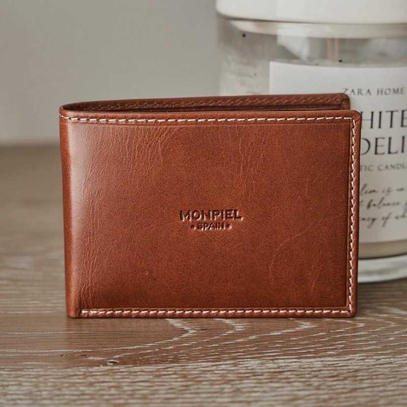 Small simple tan leather American wallet, semi-open on a wooden table with a front view - MONPIEL