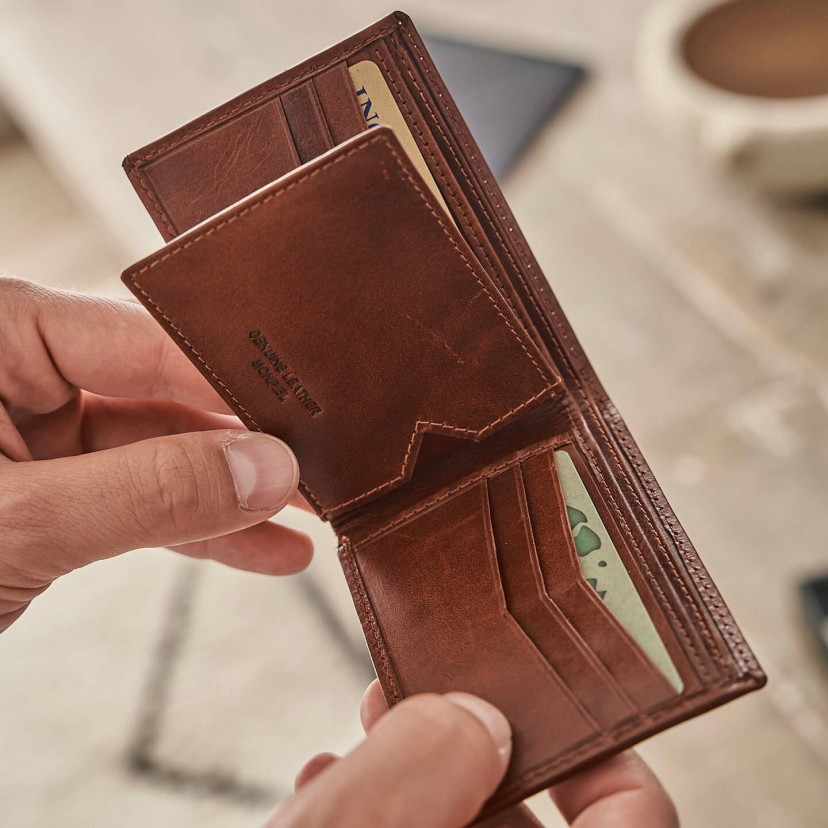 Small simple tan leather American wallet, open in hands with card slot details - MONPIEL