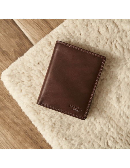 Double-stitched leather wallet in brown, front view and slightly tilted resting on a rug - MONPIEL Double-stitched leather wallet in brown, front view and slightly tilted resting on a rug - MONPIEL