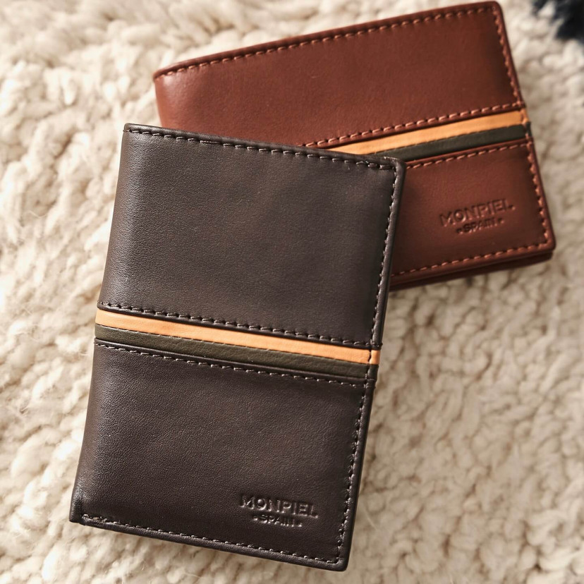Simple leather billfold with striped brown color, and a Havana leather wallet, resting on a carpet - MONPIEL