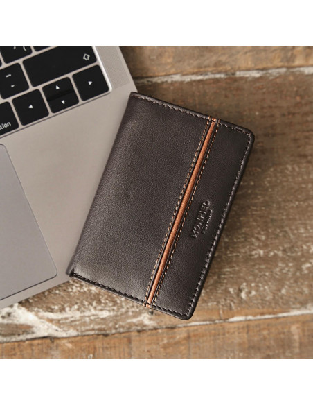 Small leather wallet with lateral stripe and coin pocket in brown, front view resting on a laptop - MONPIEL