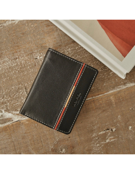 Leather wallet with coin pocket, featuring Spanish flag, in black color, front view, on a wooden table - MONPIEL Leather wallet with coin pocket, featuring Spanish flag, in black color, front view, on a wooden table - MONPIEL