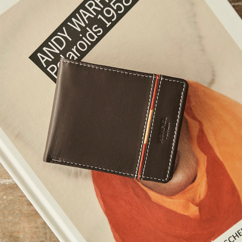 Large American-style leather wallet featuring Spanish flag, in brown color, front view, on a book - MONPIEL