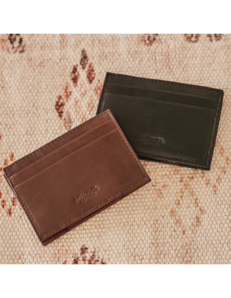 Magical leather cardholder in Havana and black, front view on a carpet - MONPIEL