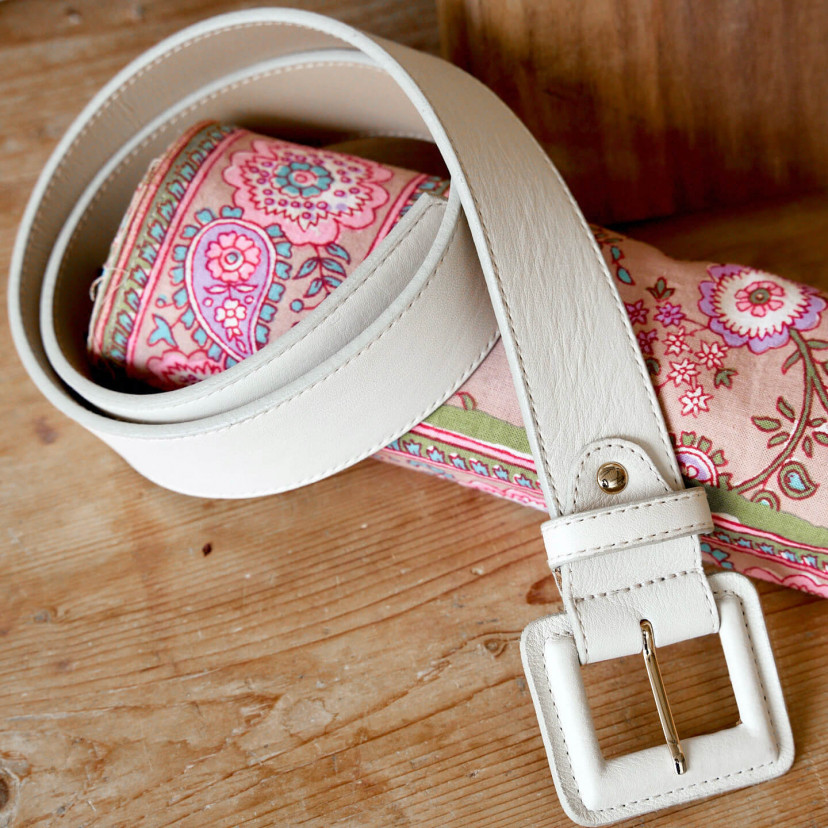 Wide women's leather belt with covered buckle in beige color, coiled on a fabric scarf - MONPIEL