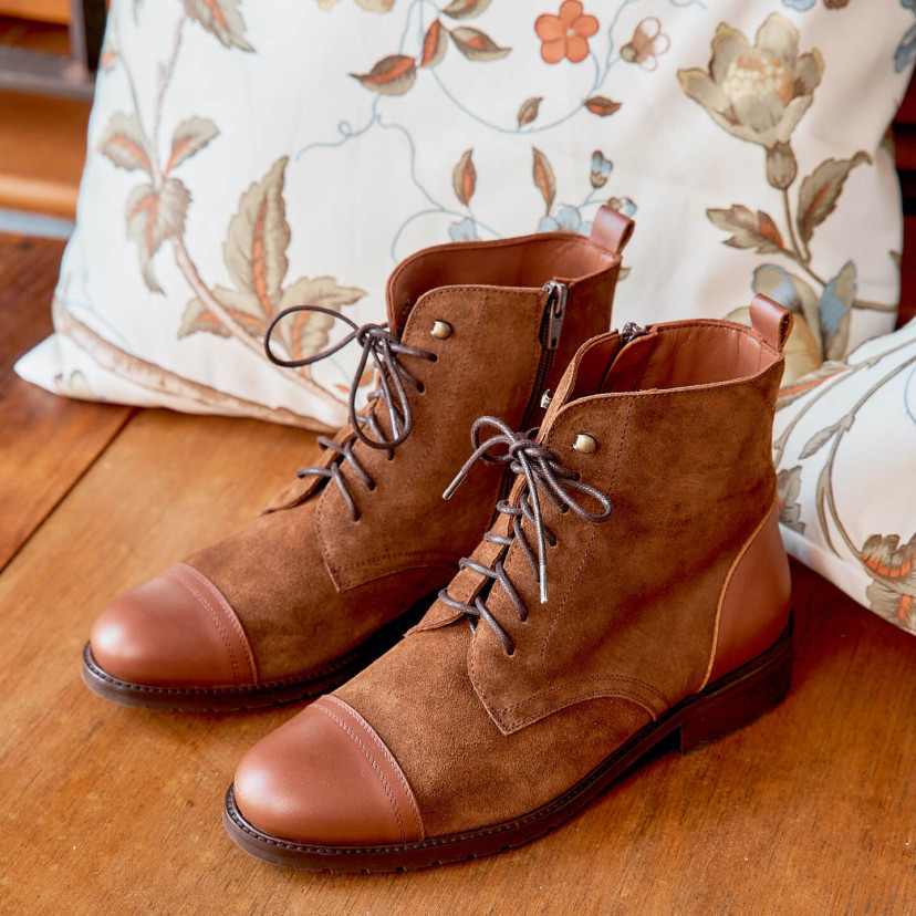 Women’s leather lace-up ankle boots in tan color, angled view on wooden floor - MONPIEL