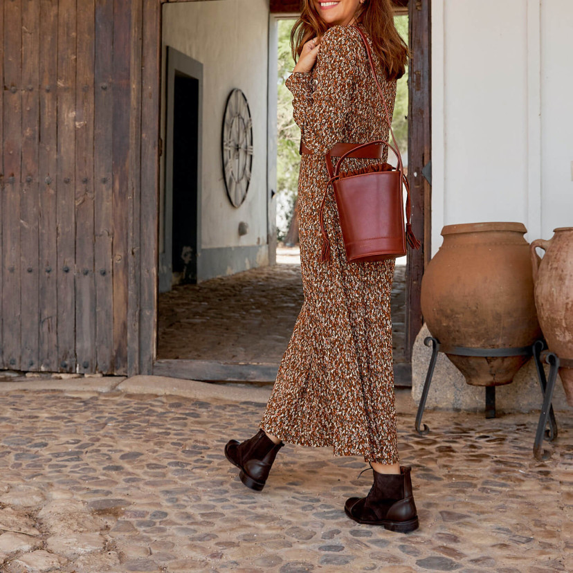 Women’s leather lace-up ankle boots in brown color, full shot in motion outdoors - MONPIEL