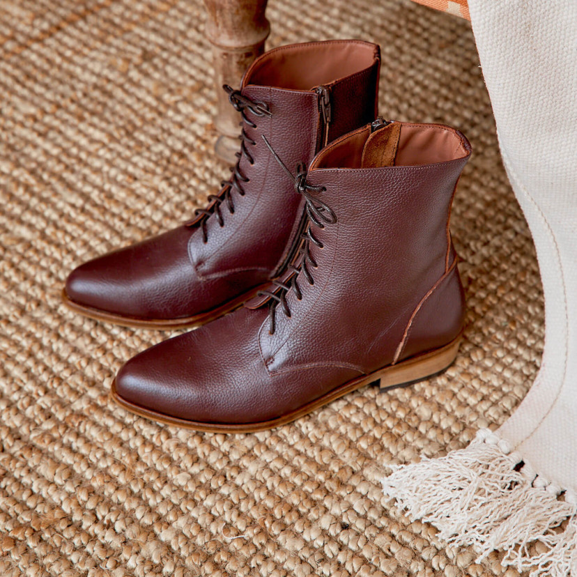 Women’s leather pointed-toe ankle boots in burgundy color, angled view, on a rug - MONPIEL