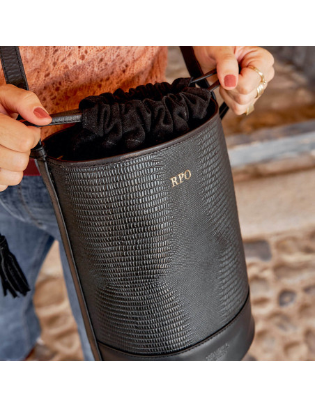 Three custom gold-engraved initials on a black leather cube bag with snake print, closing the drawstring - MONPIEL