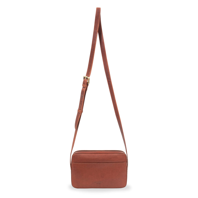 Tan leather crossbody bag, front view, with long strap detail, on a white background - MONPIEL