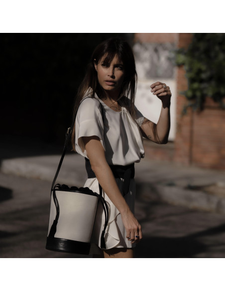 Canvas leather bucket bag in black color, worn on the shoulder outdoors - MONPIEL Canvas leather bucket bag in black color, worn on the shoulder outdoors - MONPIEL