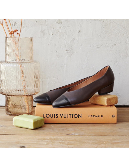 Ballerine à talon et bout bicolore en cuir marron, vue en perspective, posées sur un livre et un savon - MONPIEL Ballerine à talon et bout bicolore en cuir marron, vue en perspective, posées sur un livre et un savon - MONPIEL