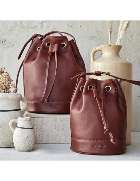 Large leather bucket bag in tan color, small bag beside it, close-up - MONPIEL