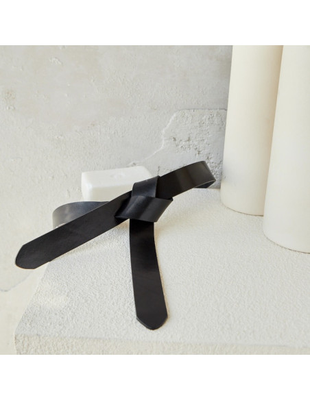 Black leather vaquetilla knotted belt, closed, next to soap - MONPIEL