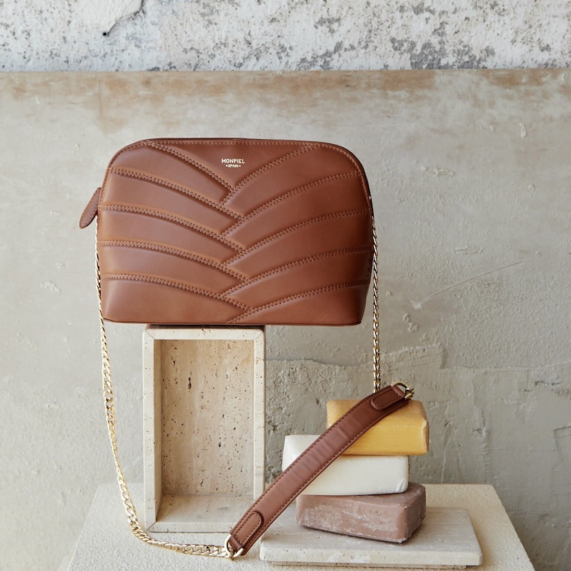 Quilted leather bag with gold chain in tan color, next to soap - MONPIEL