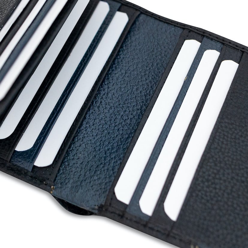 Black leather wallet with elastic band and card slots, close-up view - MONPIEL